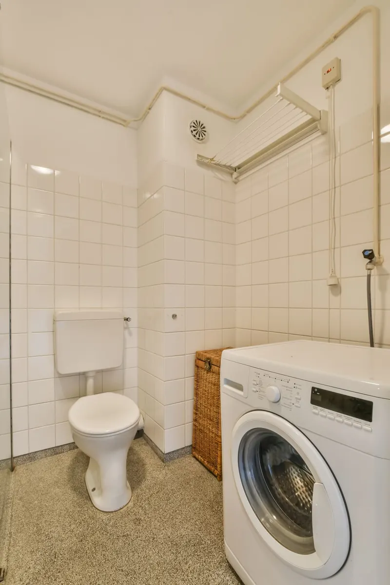 Front-load washing machine in a tiled laundry room