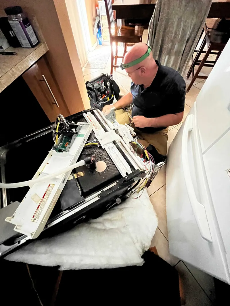 Technician working on a dishwasher control board